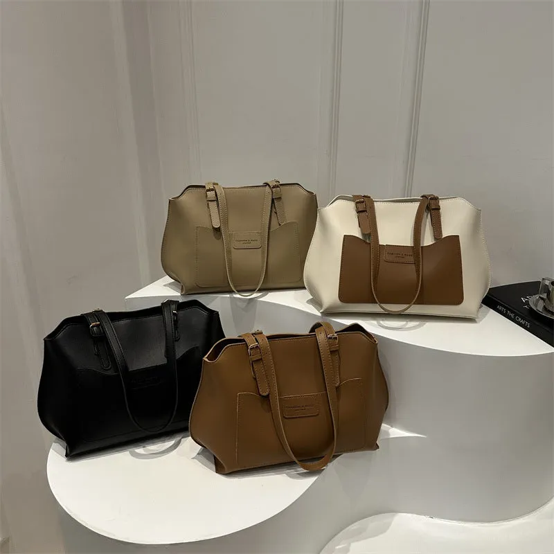 Women's square PU tote bag in black with double straps, showing external sandwich pocket and sewing line detail.
