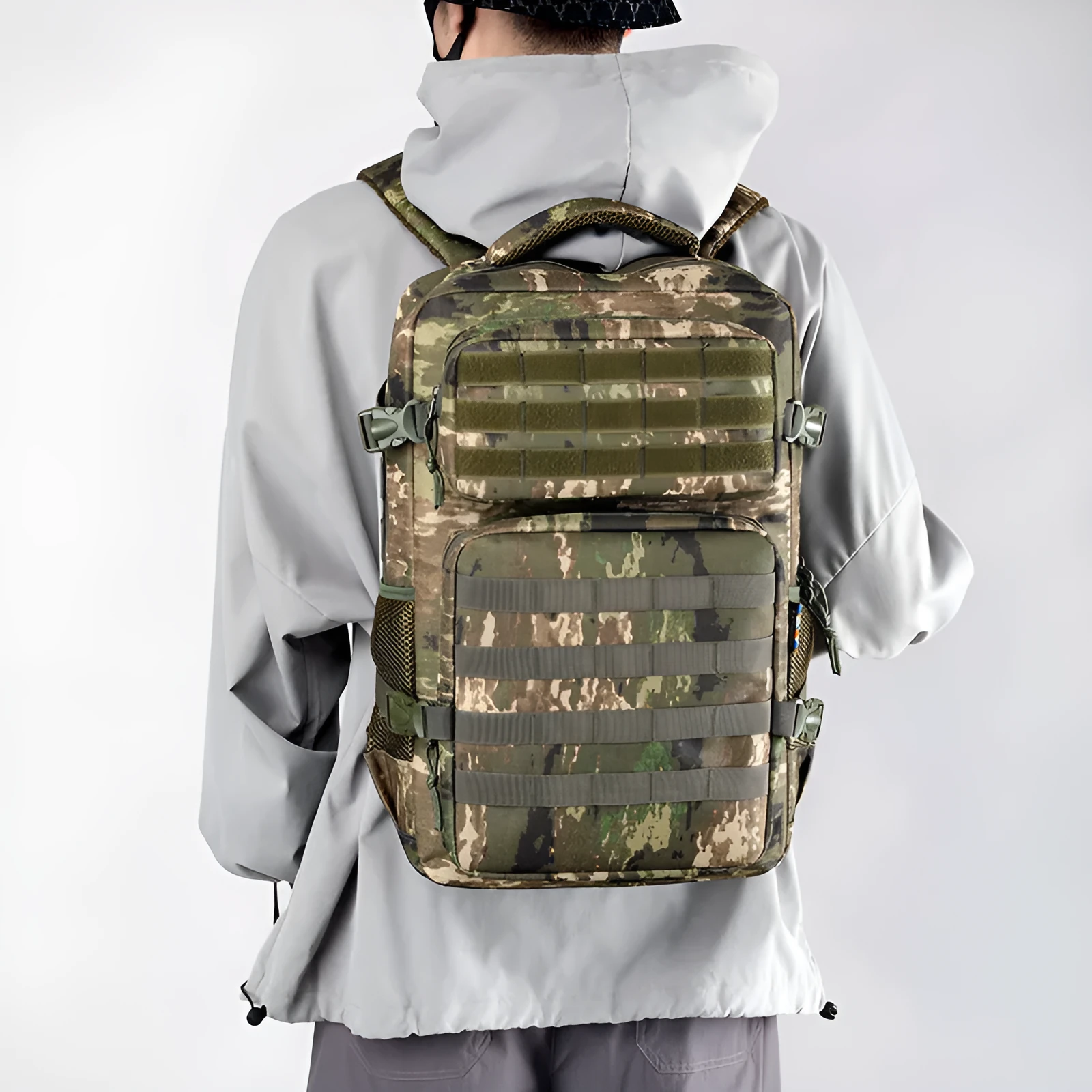 Outdoor mountaineering backpack in camouflage colour with curved shoulder straps and multiple compartments