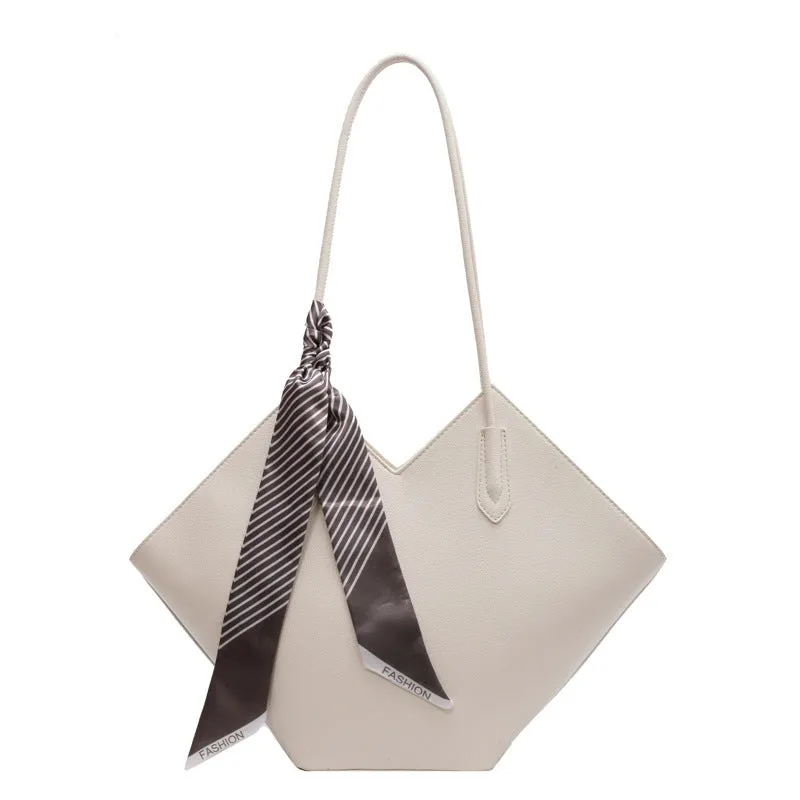 Women's large beige PU leather shoulder bag with a square shape and single handle on a neutral background.
