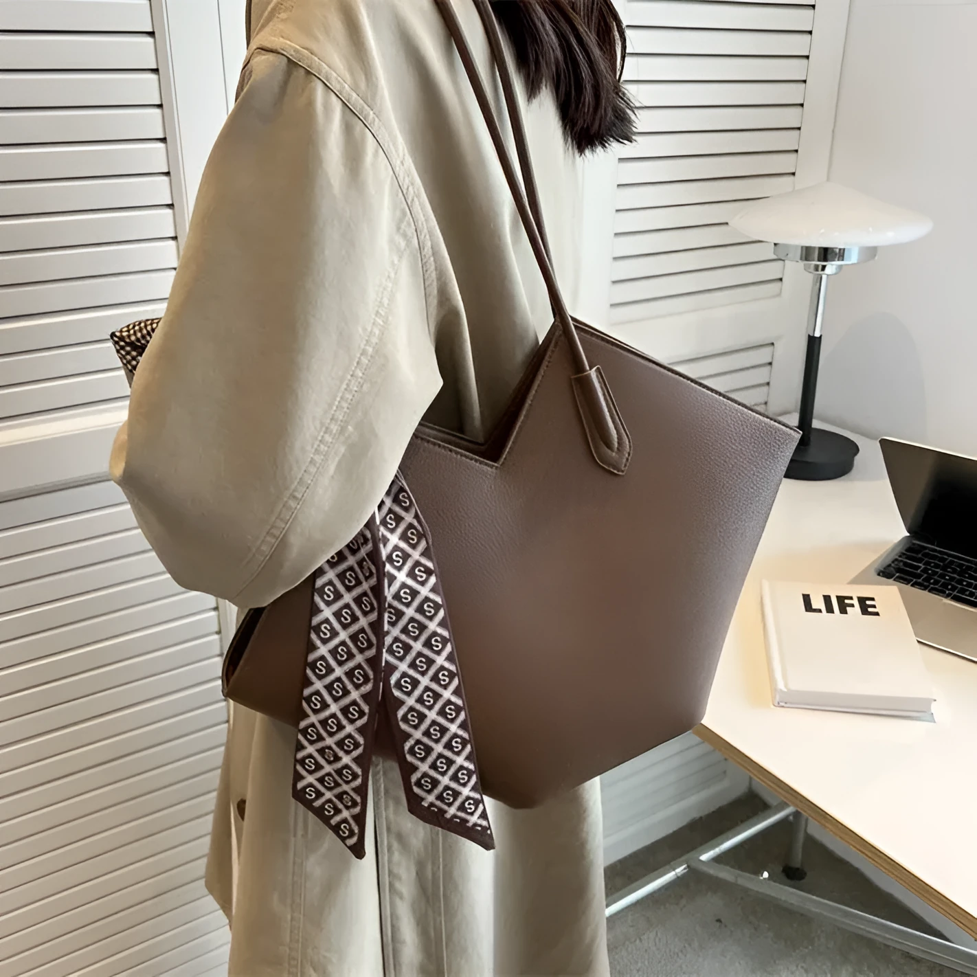 Women's large beige PU leather shoulder bag with a square shape and single handle on a neutral background.