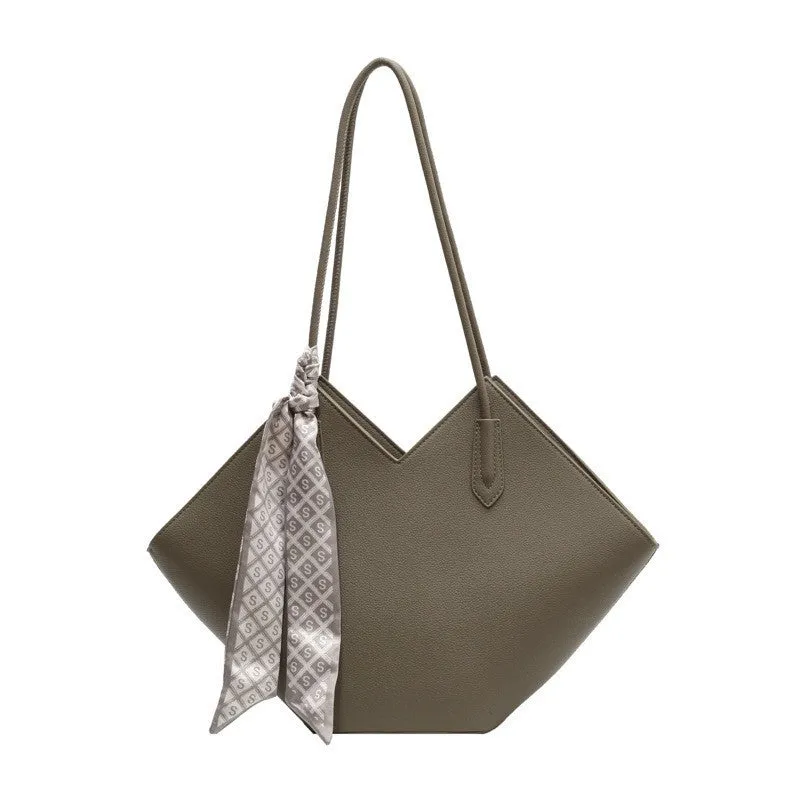Women's large beige PU leather shoulder bag with a square shape and single handle on a neutral background.