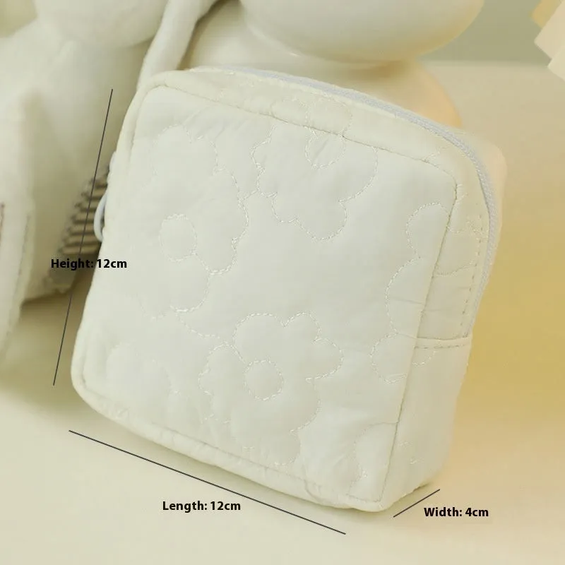 Quilted silk cosmetic bag in candy colours showing pink, yellow, blue, white, and green options
