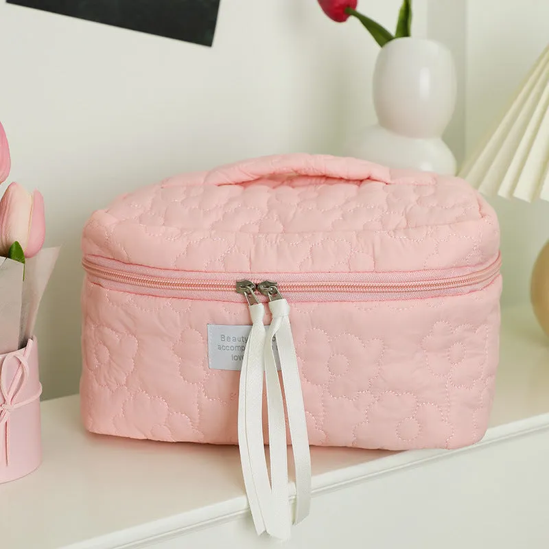 Quilted silk cosmetic bag in candy colours showing pink, yellow, blue, white, and green options