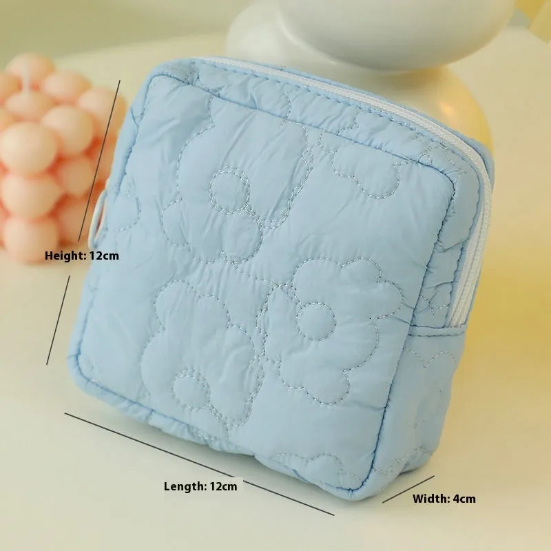 Quilted silk cosmetic bag in candy colours showing pink, yellow, blue, white, and green options