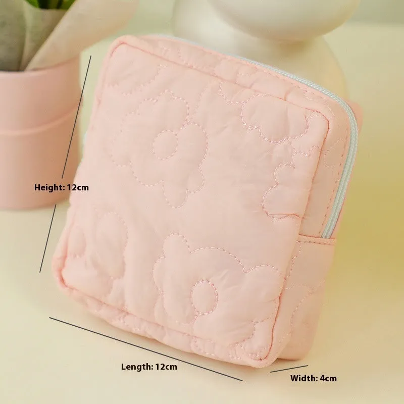 Quilted silk cosmetic bag in candy colours showing pink, yellow, blue, white, and green options