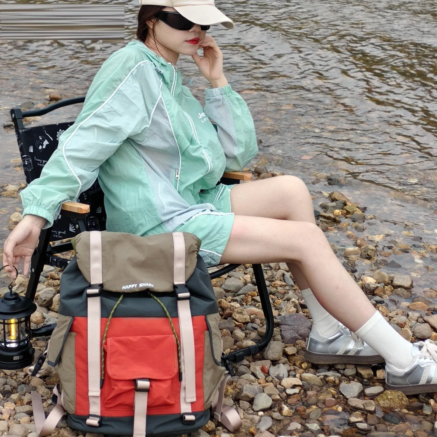 Orange green contrast colour outdoor backpack with multiple compartments and air pillow belt system