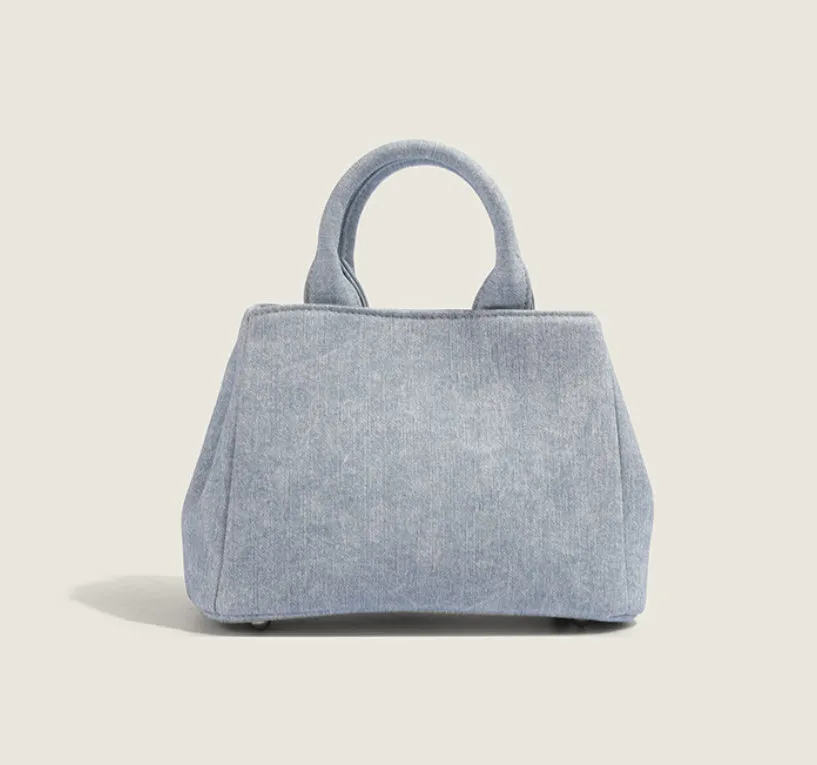 Women's casual shoulder bag made from soft PU material in denim blue colour with standard size dimensions