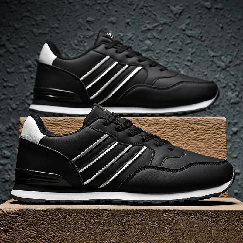 Men's black casual running shoes with a white carved wing pattern on the leather upper.