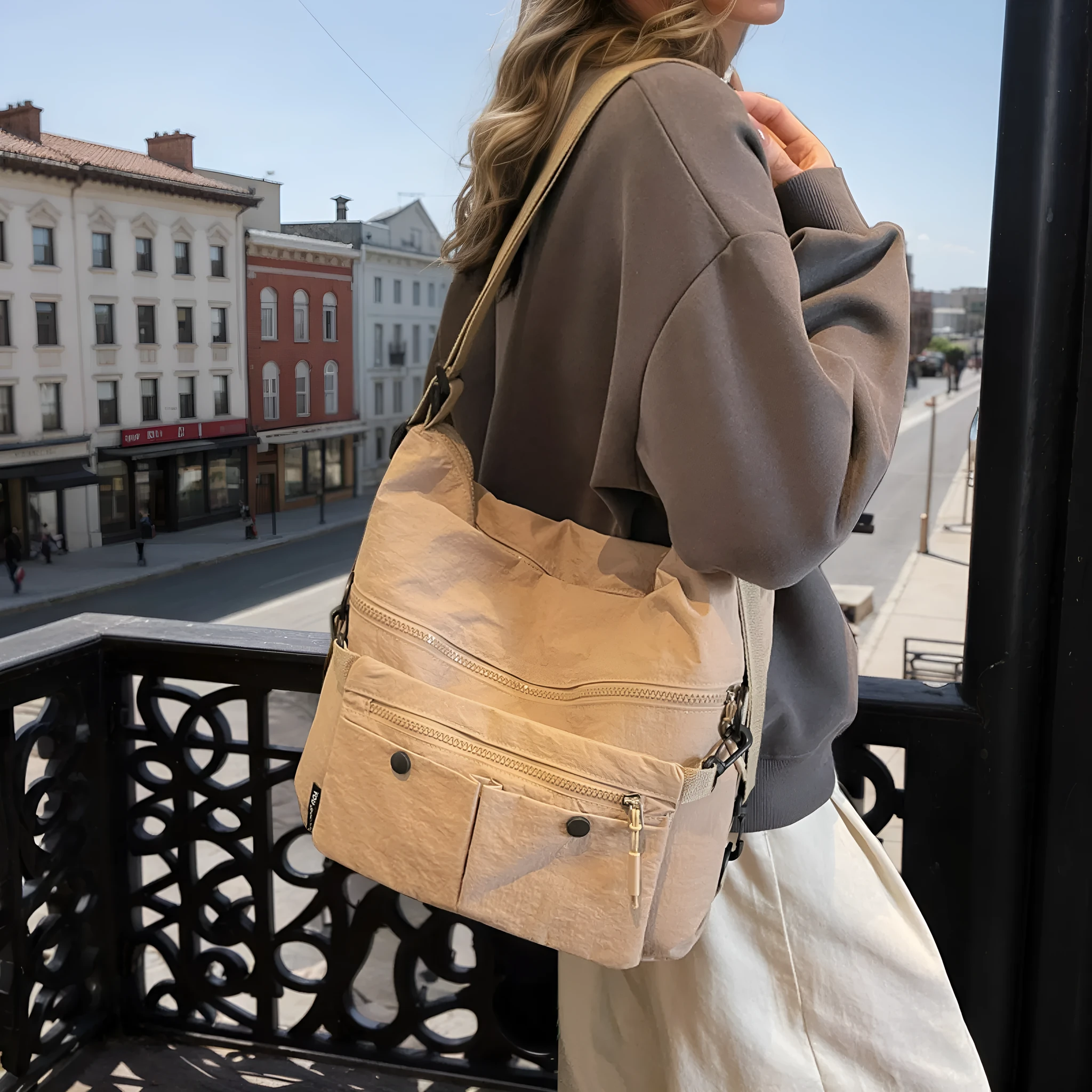 Women's nylon crossbody bag with double shoulder straps showing multiple pockets in black colour