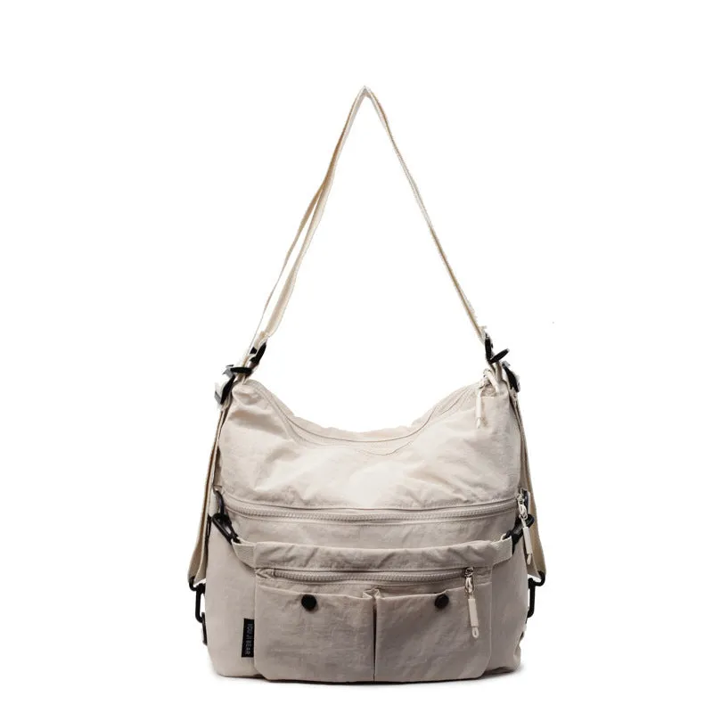 Women's nylon crossbody bag with double shoulder straps showing multiple pockets in black colour