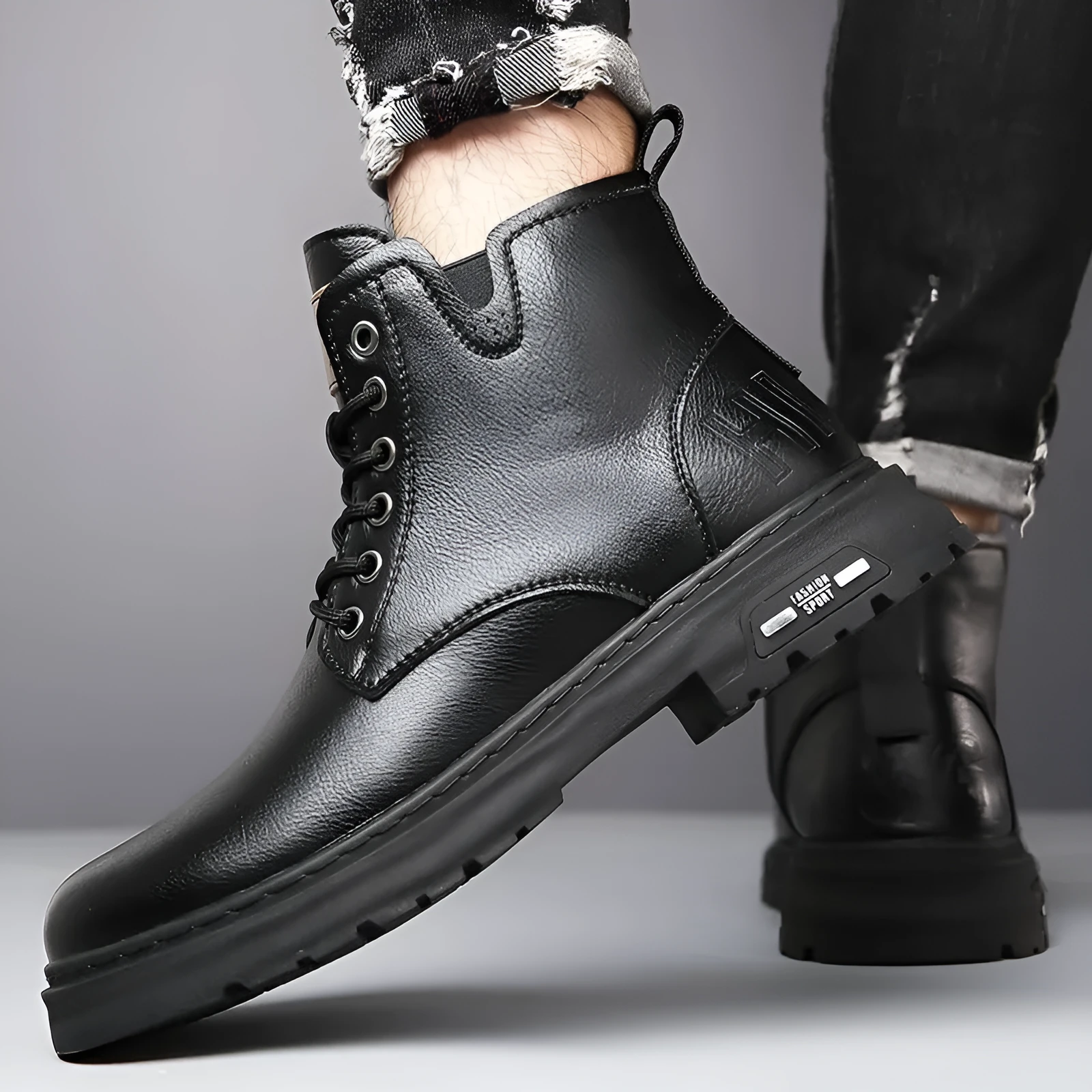 Men's black British Martin lace-up boots with thick rubber sole and round toe on a neutral background.