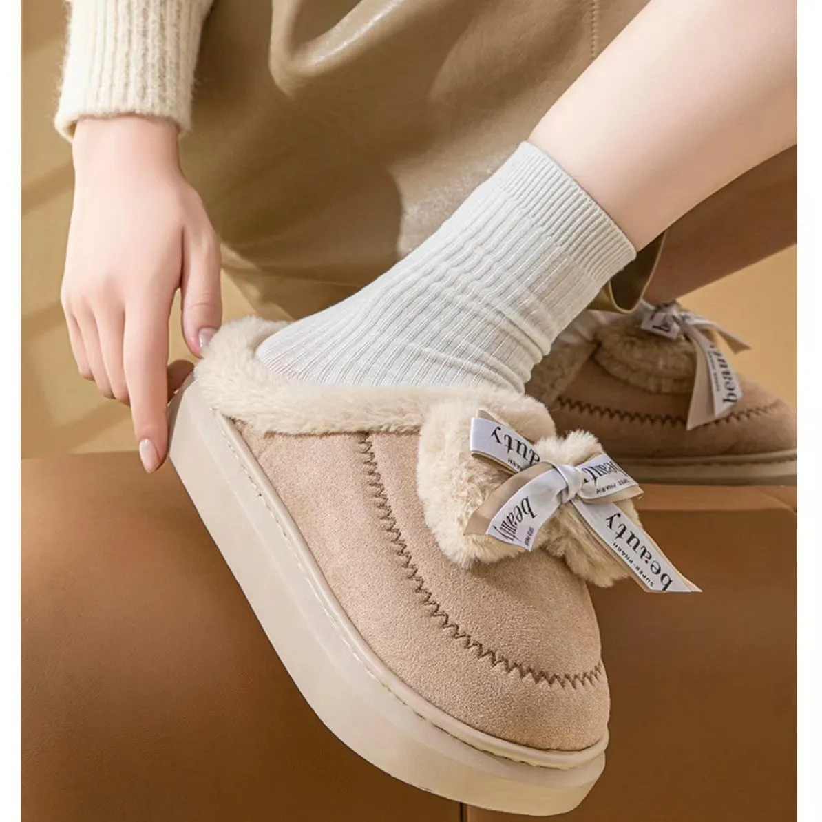 Women's beige suede half slippers with a black ribbon bow and thick white EVA sole