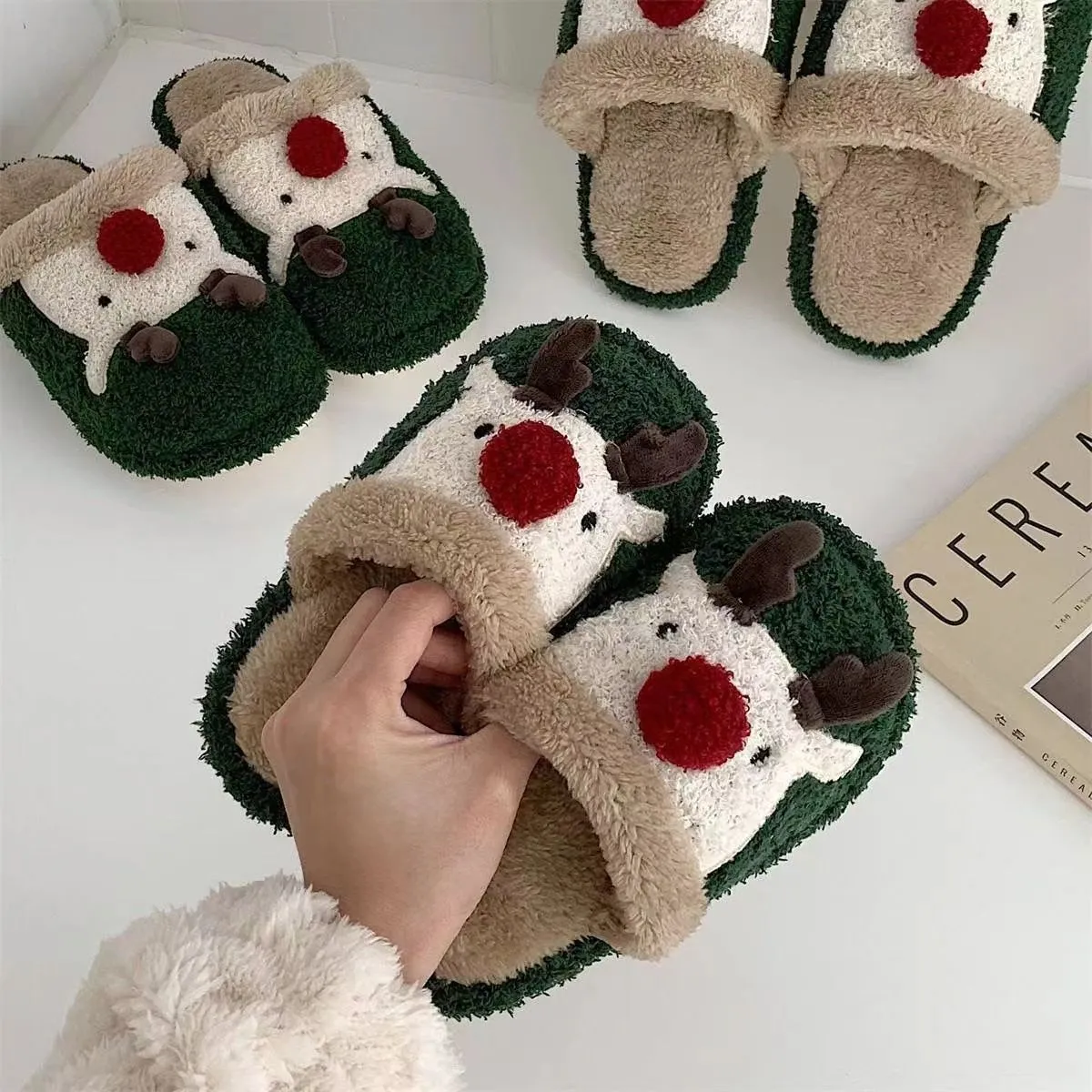 Women's green Christmas deer plush slippers with non-slip PVC soles.