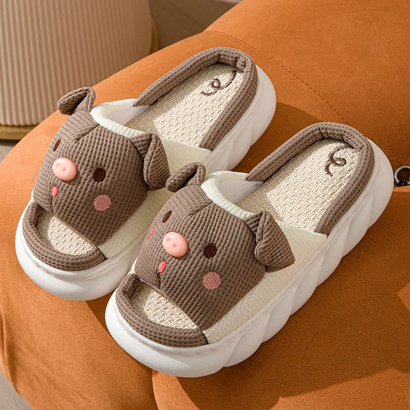 White linen open toe flip flop slippers for couples on a light background, showing PVC sole and strap detail.