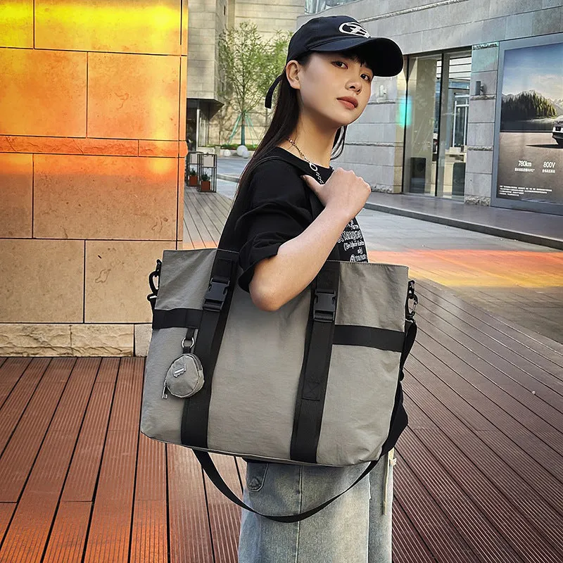 Grey Oxford cloth men's travel shoulder bag showing main compartment and detachable coin purse.