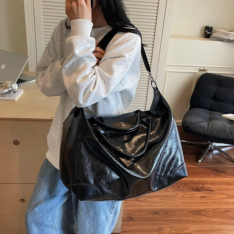 Women's black hand-carry travel bag with 36-55L capacity and polyester lining