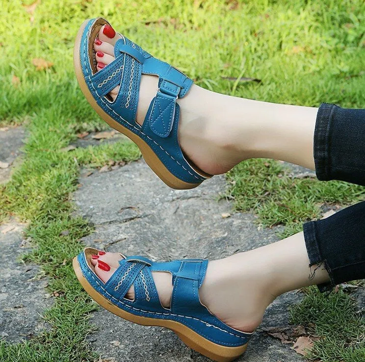 Women's red peep toe wedge sandals with Velcro strap on a fish mouth sole.