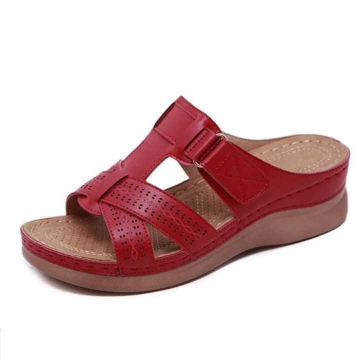 Women's red peep toe wedge sandals with Velcro strap on a fish mouth sole.