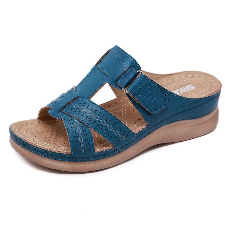 Women's red peep toe wedge sandals with Velcro strap on a fish mouth sole.
