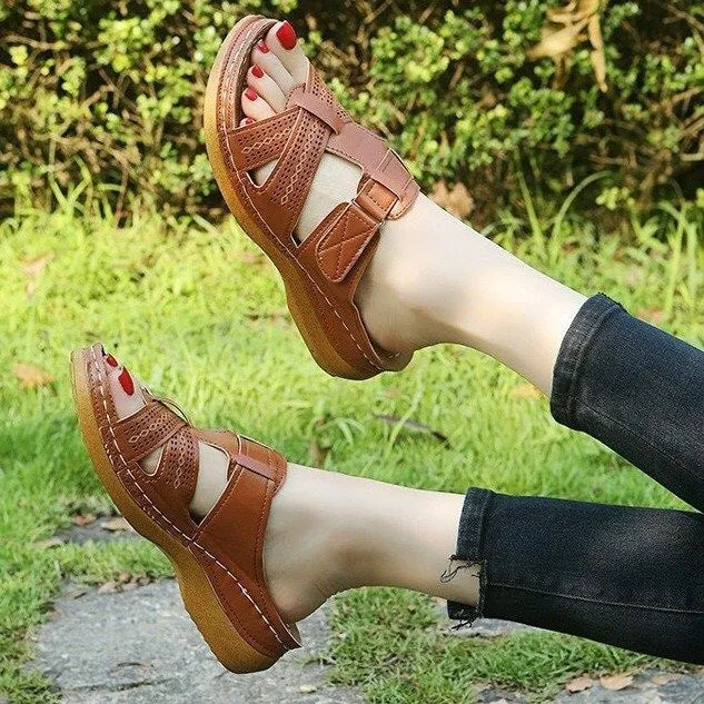 Women's red peep toe wedge sandals with Velcro strap on a fish mouth sole.