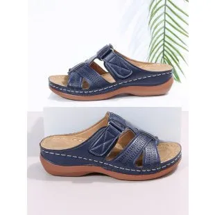 Women's red peep toe wedge sandals with Velcro strap on a fish mouth sole.