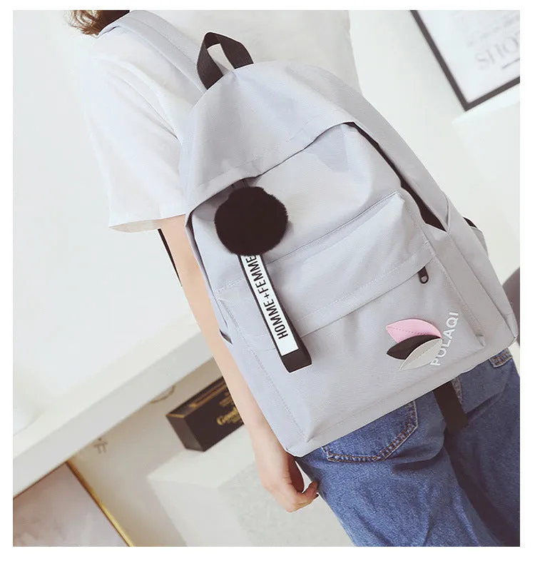Canvas college backpack with leaf pattern in green colour showing front compartment and straps
