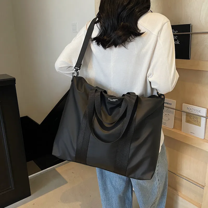 Lightweight oxford cloth tote bag in black, grey, or champagne for business travel.