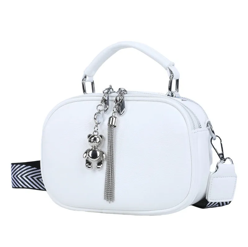 Oval-shaped women's small square handbag in PU with stitching detail and double straps.