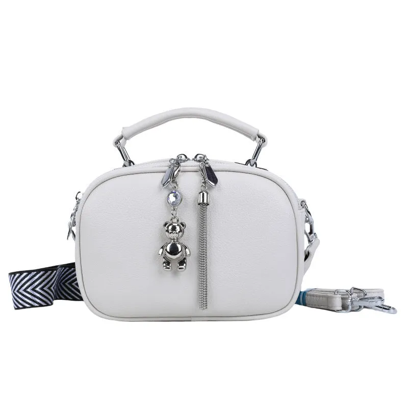 Oval-shaped women's small square handbag in PU with stitching detail and double straps.