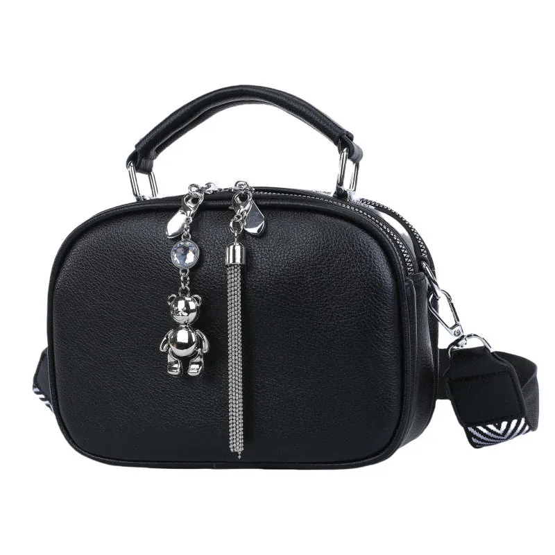Oval-shaped women's small square handbag in PU with stitching detail and double straps.