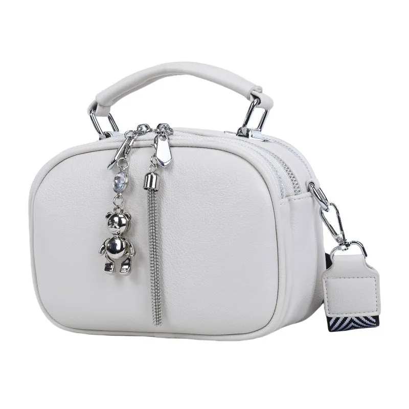 Oval-shaped women's small square handbag in PU with stitching detail and double straps.