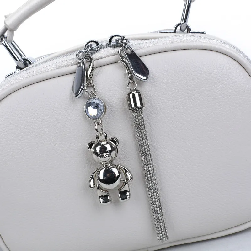 Oval-shaped women's small square handbag in PU with stitching detail and double straps.