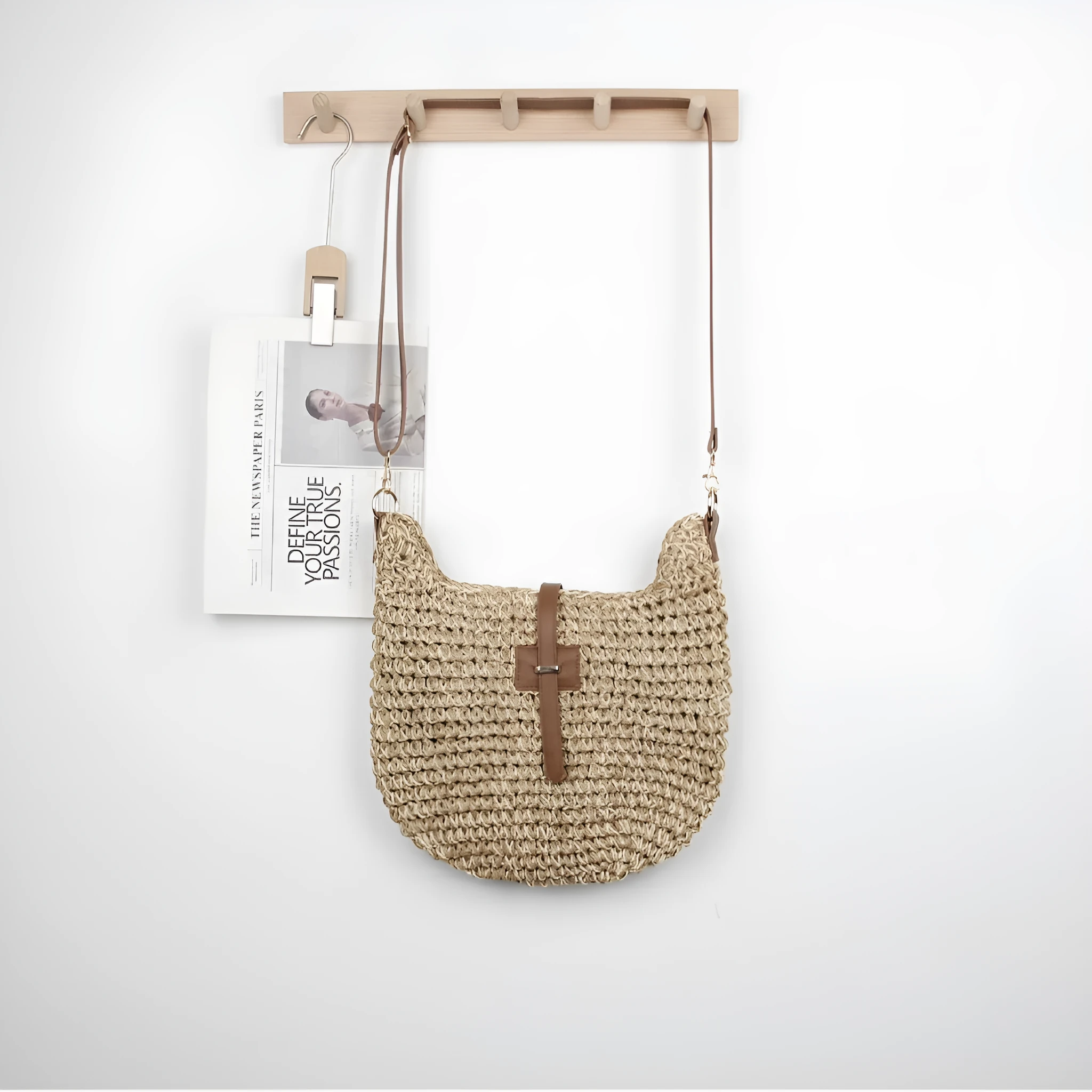 Handmade beige square woven bag with a shoulder strap on a neutral background.