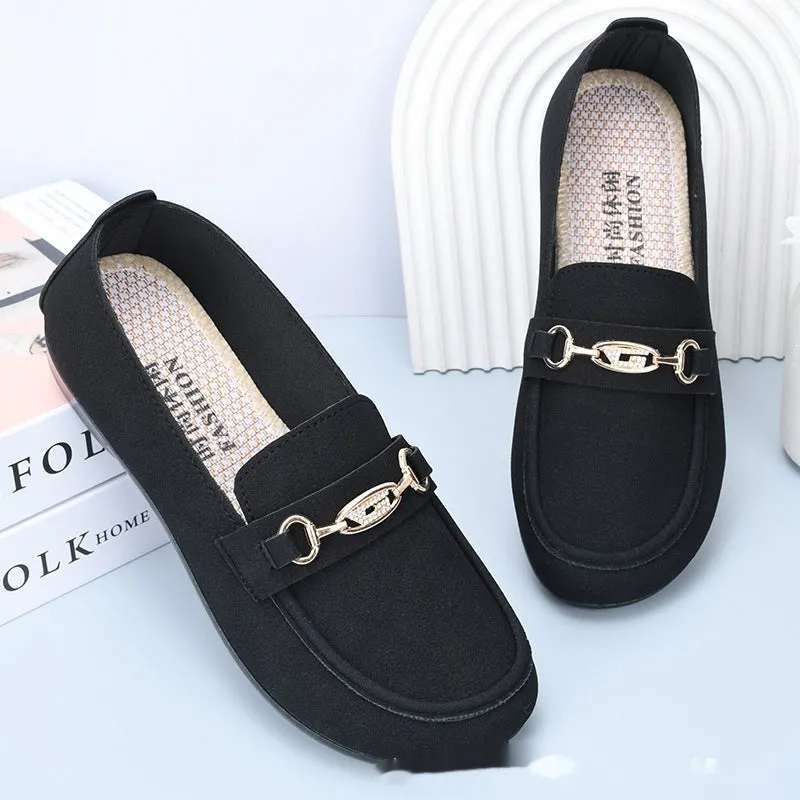 Women's black matte slip-on casual shoes with a round toe and soft rubber sole on a flat surface.