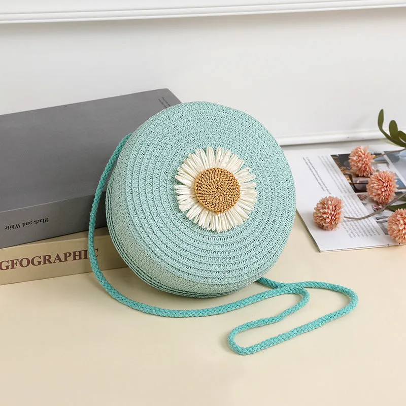 Woven straw crossbody bag in pastoral style, shown in one of eight colours, designed to hold a mobile phone.
