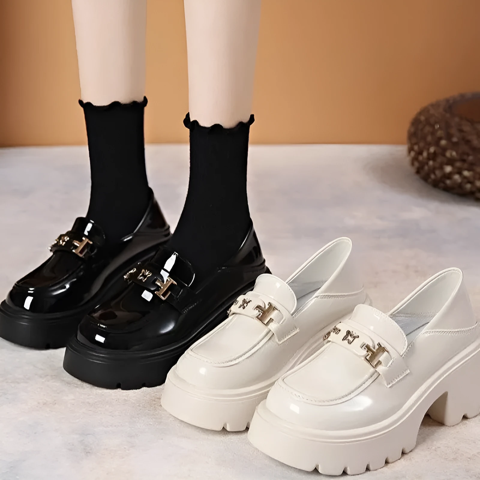 Black women's slip-on shoes with a skull pattern, chunky square heel, and round toe on a white background.