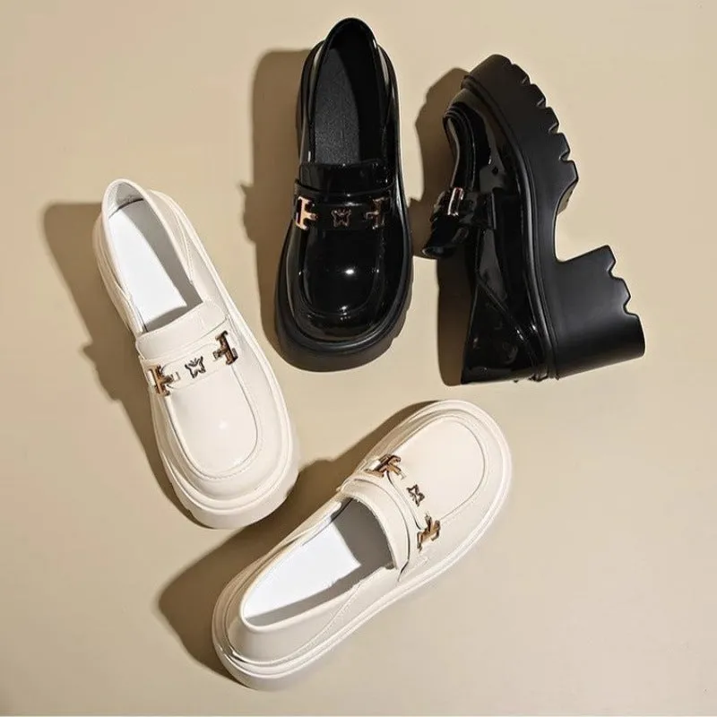 Black women's slip-on shoes with a skull pattern, chunky square heel, and round toe on a white background.