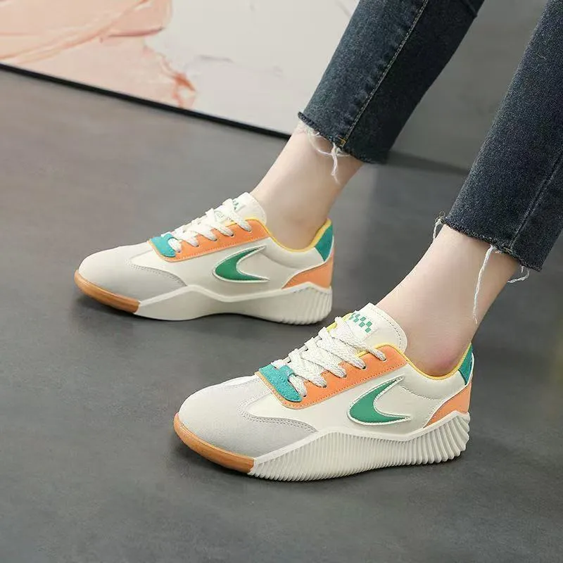 Low-top casual sneaker in beige orange with round toe and flat rubber sole.