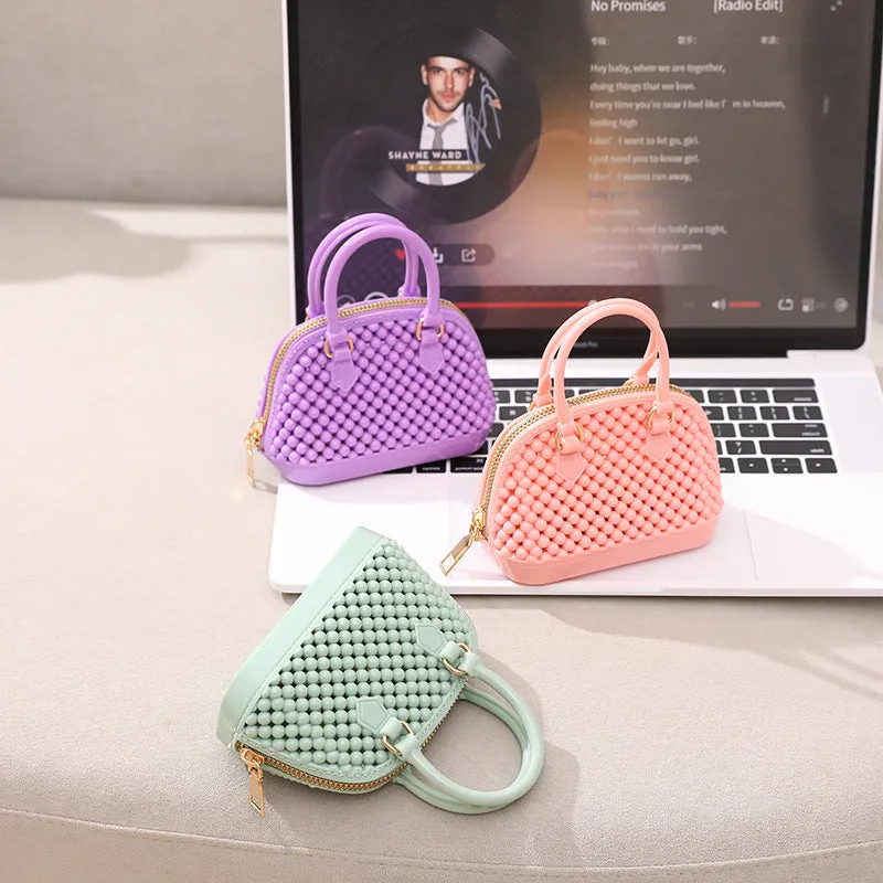 Translucent PVC jelly shell handbag with hollowed design and metal chain strap in apricot colour