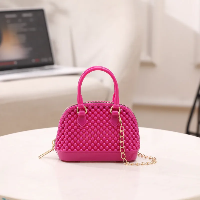 Translucent PVC jelly shell handbag with hollowed design and metal chain strap in apricot colour