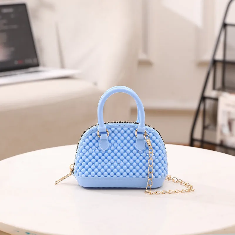 Translucent PVC jelly shell handbag with hollowed design and metal chain strap in apricot colour