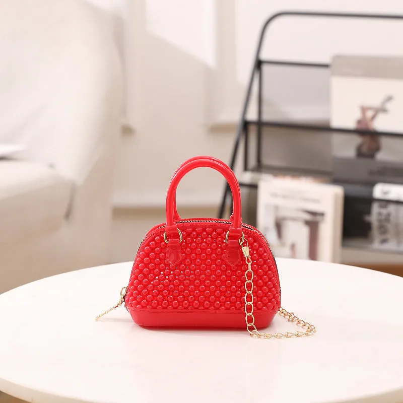 Translucent PVC jelly shell handbag with hollowed design and metal chain strap in apricot colour