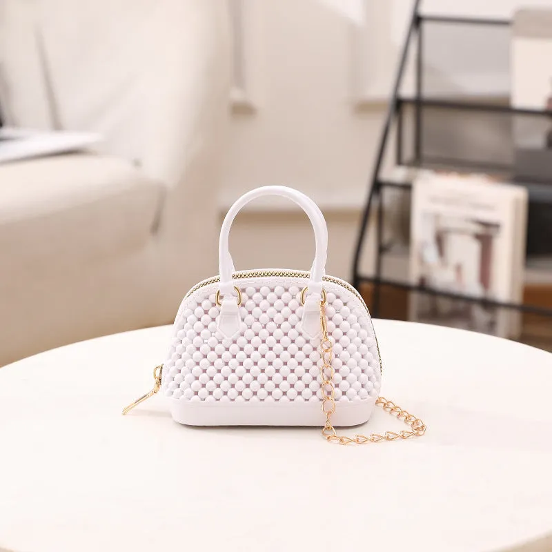 Translucent PVC jelly shell handbag with hollowed design and metal chain strap in apricot colour