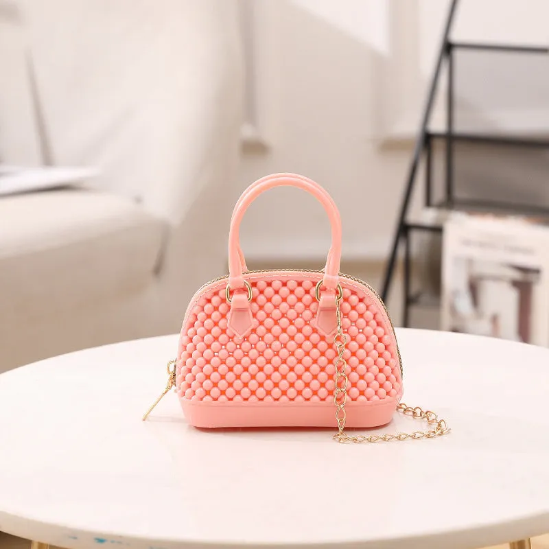 Translucent PVC jelly shell handbag with hollowed design and metal chain strap in apricot colour