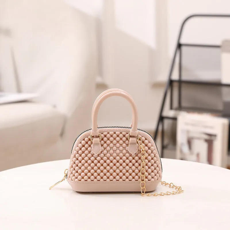Translucent PVC jelly shell handbag with hollowed design and metal chain strap in apricot colour