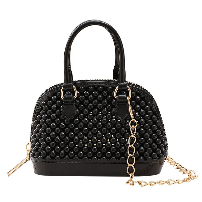 Translucent PVC jelly shell handbag with hollowed design and metal chain strap in apricot colour