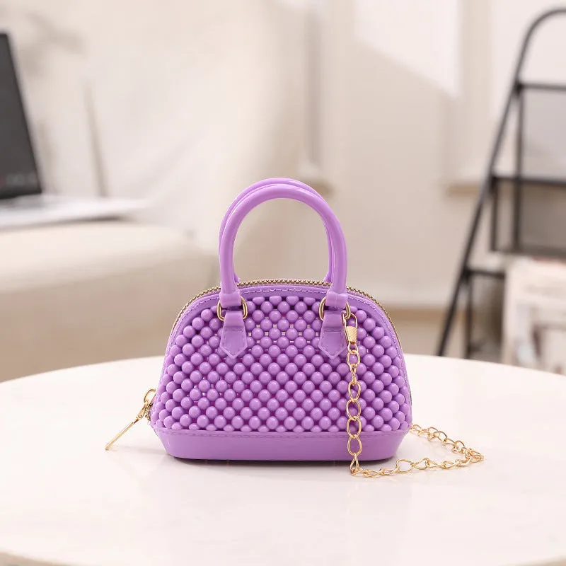 Translucent PVC jelly shell handbag with hollowed design and metal chain strap in apricot colour