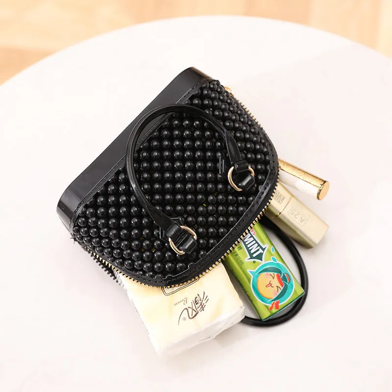 Translucent PVC jelly shell handbag with hollowed design and metal chain strap in apricot colour