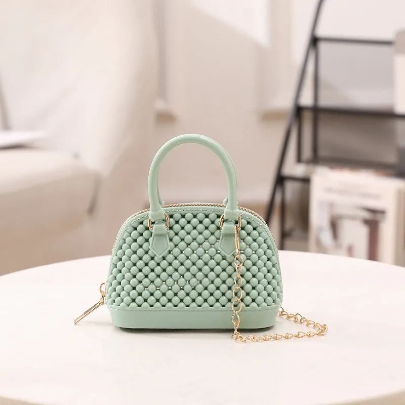 Translucent PVC jelly shell handbag with hollowed design and metal chain strap in apricot colour