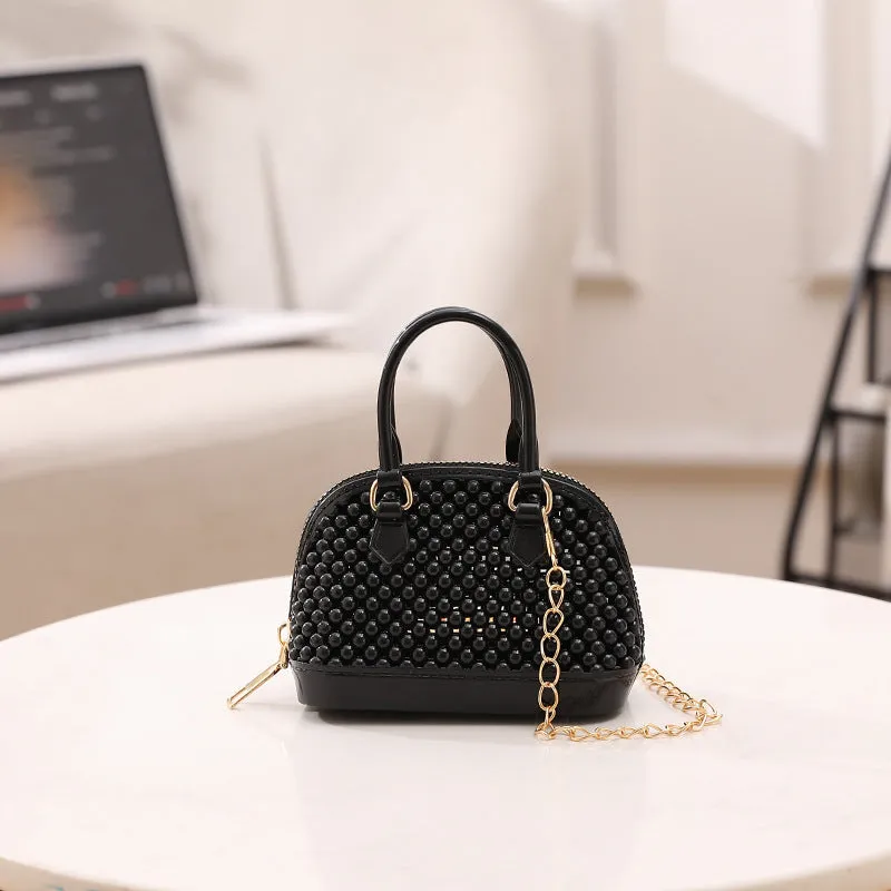 Translucent PVC jelly shell handbag with hollowed design and metal chain strap in apricot colour